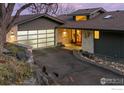 Home's exterior featuring a modern design, glass garage door, and stone accents at 230 Cactus Ct, Boulder, CO 80304