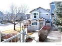 Tan two-story townhome with landscaping and walkway at 4110 Riley Dr, Longmont, CO 80503