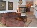Living room with fireplace, sitting area, and view to dining area at 4110 Riley Dr, Longmont, CO 80503