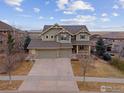 Two-story house with a three-car garage and landscaping; street view at 7690 S Blackstone Pkwy, Aurora, CO 80016