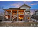 Multi-level deck and stone patio, with a walkout basement, enhances the outdoor living space of this beautiful home at 7690 S Blackstone Pkwy, Aurora, CO 80016