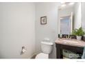 Well-lit half bathroom with granite countertop and updated fixtures creates a neat space at 3035 Oneal Pkwy # 21, Boulder, CO 80301