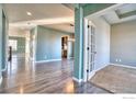 Bright hallway with hardwood floors and access to various rooms at 6918 Purdue Ave, Firestone, CO 80504