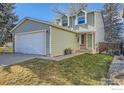 Charming two-story home with a spacious yard and attached garage at 8093 Miller Cir, Arvada, CO 80005