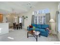 Cozy living room featuring a teal sofa and large windows at 10710 Eliot Cir # 101, Westminster, CO 80234