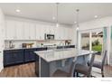 Modern kitchen with granite countertops and blue cabinets at 1127 Highlands Dr, Erie, CO 80516