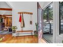 Inviting entryway with wooden floors, a bench, and a glimpse of the outdoor deck, creating a warm and welcoming ambiance at 160 Bristlecone Way, Boulder, CO 80304