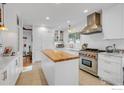 Bright kitchen features stainless appliances, butcher block island, and white cabinets at 160 Bristlecone Way, Boulder, CO 80304