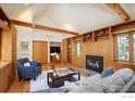 Open living room with fireplace and built-in bookshelves, perfect for relaxing and entertaining at 160 Bristlecone Way, Boulder, CO 80304