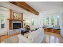 Cozy living room with fireplace, built-in seating and sun-filled windows with forest views at 160 Bristlecone Way, Boulder, CO 80304