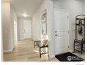 Bright and airy entryway with light flooring and a built-in bench at 1860 Miranda Rd, Erie, CO 80516