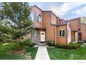 Charming townhome featuring updated siding, stone accents, and a well-manicured lawn and mature trees at 6158 Habitat Dr, Boulder, CO 80301