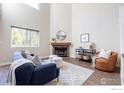 Bright living room featuring a brick fireplace, hardwood floors, and modern decor with natural light at 6158 Habitat Dr, Boulder, CO 80301