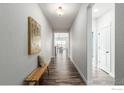 Bright and airy entryway with wood-look floors and a bench at 808 Lowrey Ln, Berthoud, CO 80513