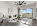 Living room with sliding glass doors leading to a deck and scenic views at 808 Lowrey Ln, Berthoud, CO 80513