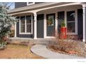 Charming home exterior with a welcoming front porch and landscaping at 908 Clover Cir, Lafayette, CO 80026