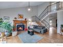 Bright living room with a fireplace and hardwood floors at 908 Clover Cir, Lafayette, CO 80026