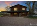 Two-story log home with large covered porch and scenic views at 12645 Foothills Hwy, Longmont, CO 80503