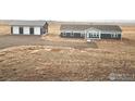 Home with detached garage; view of surrounding land at 17913 County Road 38, Platteville, CO 80651