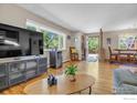 Bright living room featuring hardwood floors and a large TV at 1950 Glenwood Dr, Boulder, CO 80304