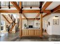 Bright entryway with exposed wooden beams, concrete floors, and a modern staircase at 2088 Alpine Dr, Boulder, CO 80304