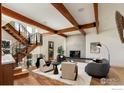 Bright living room with fireplace, hardwood floors, and stylish furniture at 2088 Alpine Dr, Boulder, CO 80304