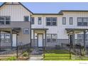 Modern two-story townhome with gray and white siding and a landscaped front yard at 2725 Bear Springs Cir, Longmont, CO 80503