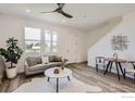 Bright and airy living room featuring a cozy seating area and large windows at 2725 Bear Springs Cir, Longmont, CO 80503