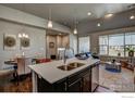 Open concept kitchen with island and living area view at 410 High Point Dr # 205, Longmont, CO 80504