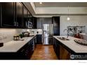 Modern kitchen with stainless steel appliances and island at 410 High Point Dr # 205, Longmont, CO 80504