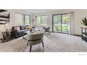 Spacious living room with comfortable seating, large windows, and access to a patio at 4648 Chestnut Ln, Boulder, CO 80301
