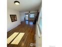 Spacious living room boasts hardwood floors and a cozy fireplace at 6213 Gray St, Arvada, CO 80003