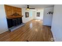 Spacious living room featuring hardwood floors, fireplace, and a ceiling fan at 6213 Gray St, Arvada, CO 80003