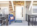 Inviting front porch with seating and charming decor at 821 Robert St, Longmont, CO 80503