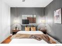 Cozy bedroom with a plush bed, modern lighting, and wall art at 2018 Ionosphere St # 8, Longmont, CO 80504