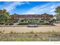 Full building view from the street, showing ample parking at 3150 Iris Ave # 303, Boulder, CO 80301