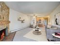 Living room with fireplace, kitchen, and comfortable seating at 3150 Iris Ave # 303, Boulder, CO 80301