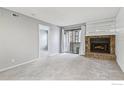 Living room with fireplace and sliding glass door to patio at 497 S Memphis Way # 10, Aurora, CO 80017