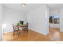 Small dining area with hardwood floors and a round wooden table at 5174 Buckingham Rd, Boulder, CO 80301