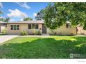 Charming single-story brick home with a well-manicured lawn and inviting curb appeal at 1232 Lincoln St, Longmont, CO 80501