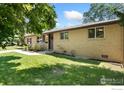 Cozy single-story house featuring a well-kept lawn, neutral brick facade, and inviting entrance at 1232 Lincoln St, Longmont, CO 80501