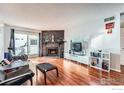 Living room with hardwood floors and fireplace at 14454 E Colorado Dr # 203, Aurora, CO 80012