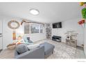 Living room with gray sectional sofa, a TV, and a cat tree at 1502 Carmelita Ct, Platteville, CO 80651