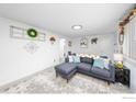 Living room with gray sectional sofa and decorative pillows at 1502 Carmelita Ct, Platteville, CO 80651