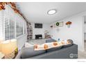 Living room with gray sectional sofa and fall decor at 1502 Carmelita Ct, Platteville, CO 80651