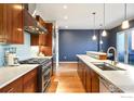 Contemporary kitchen featuring wood cabinets and a breakfast bar at 1505 Pearl St # 209, Boulder, CO 80302