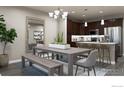 Spacious dining area with a wooden table and kitchen access at 410 High Point Dr # 104, Longmont, CO 80504