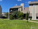 A well maintained, two-story condo building featuring a balcony and set on a large green lawn at 5540 Stonewall Pl # 16, Boulder, CO 80303