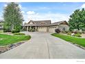 Curved driveway leads to a spacious three-car garage home at 5835 Pelican Shores Dr, Longmont, CO 80504