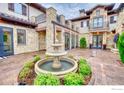 Stone patio with central fountain, lush landscaping at 6851 Goldbranch Dr, Niwot, CO 80503